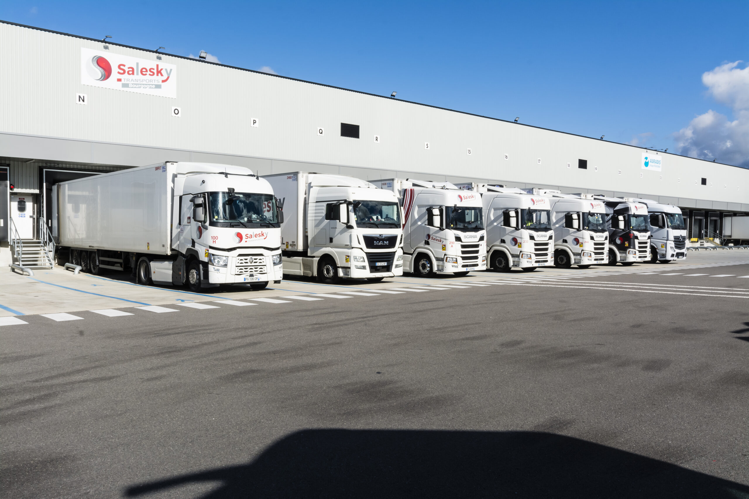 Notre entrepôt avec nos camions réfrigérés stationnés